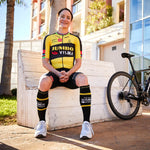 Marianne Vos in bicycle clothing with buildings in the background.