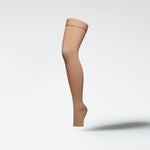 Front view of a medical thigh high stocking in sand.